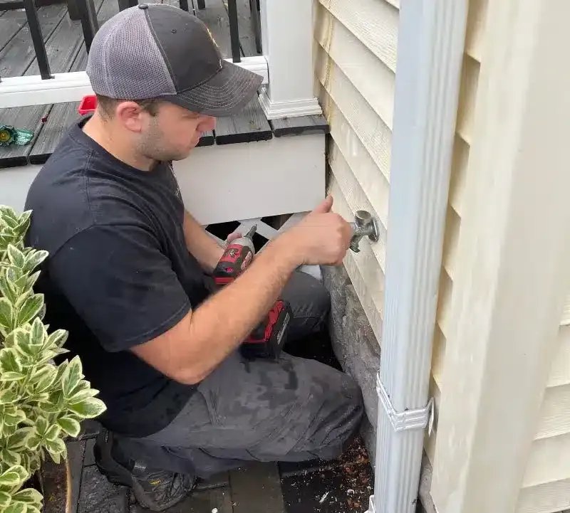 Tech working on outside water spigot in Hillsdale, NJ.