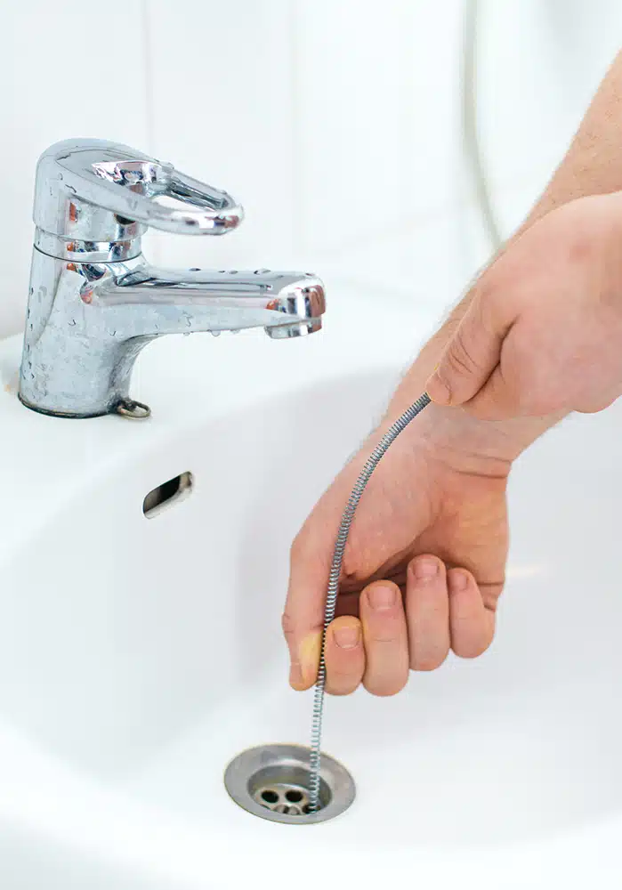 Drain snake in bathroom sink in residential home in Hillsdale, NJ.